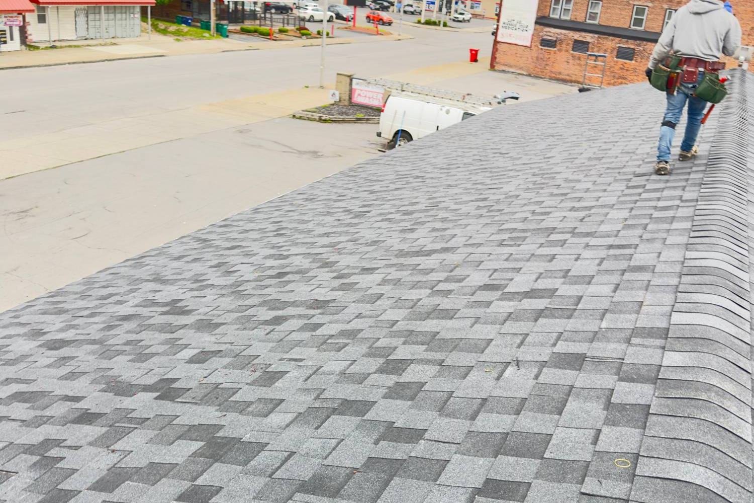 TopCraft roofer walking the ridge of a newly shingled roof